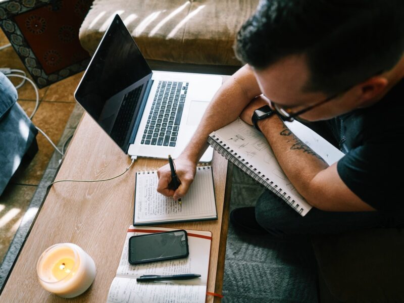 man writing notes
