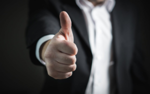 Man in suit with his thumb up